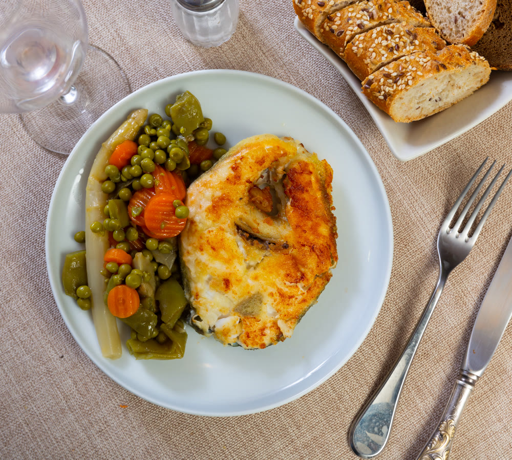 Bacalhau fillet served with stewed vegetables