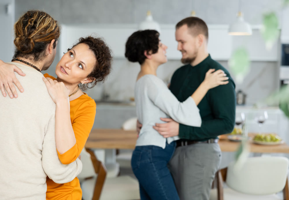 Friends dancing. Cheerful young people dancing and drinking while enjoying home party on room