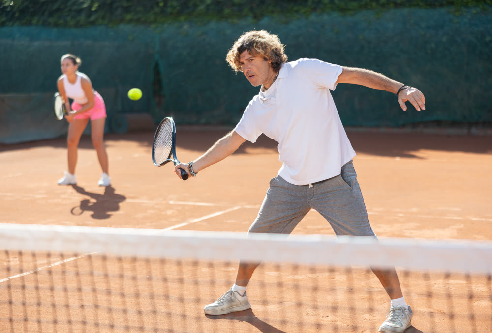 woman plays tennis with a fly woman