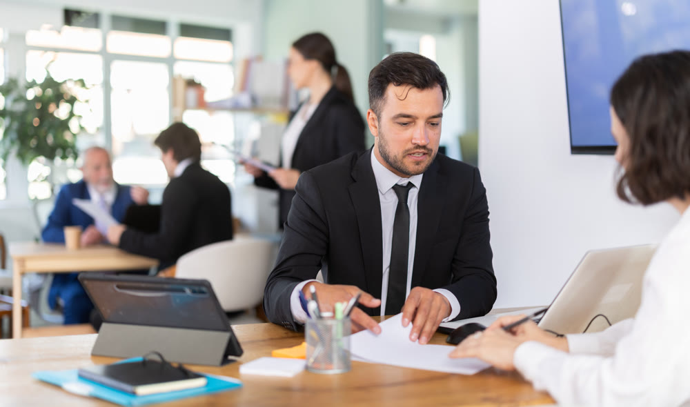 Bank manager talking with female client in office