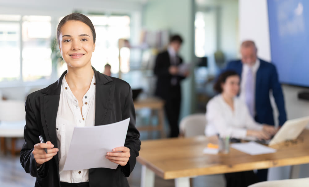 Young woman taking notes in document