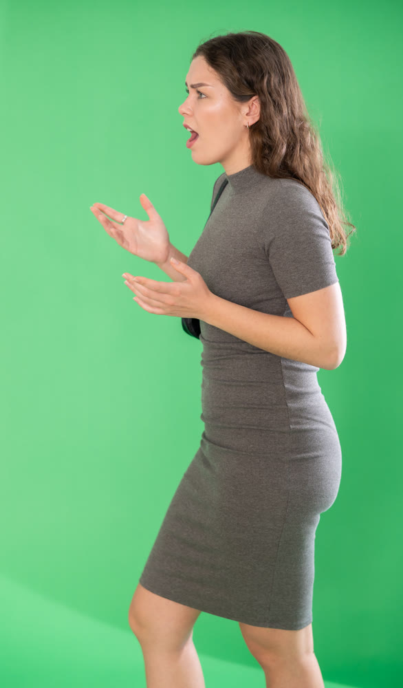 Aggressive woman expresses negative emotions by screaming and waving her arms. Chroma key compositing