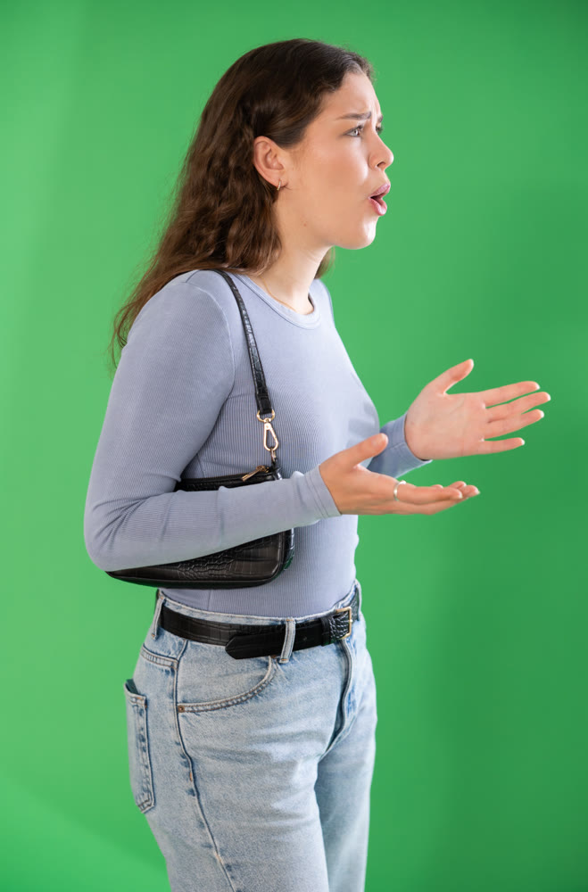 Aggressive woman expresses negative emotions by screaming and waving her arms. Chroma key compositing