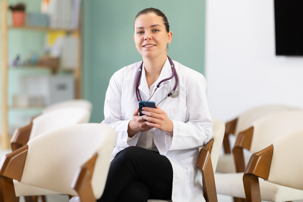 Young woman medical student listening to lecture with phone