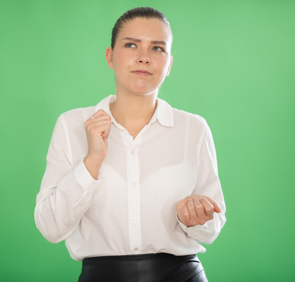 Young girl on green screen background has forgotten something