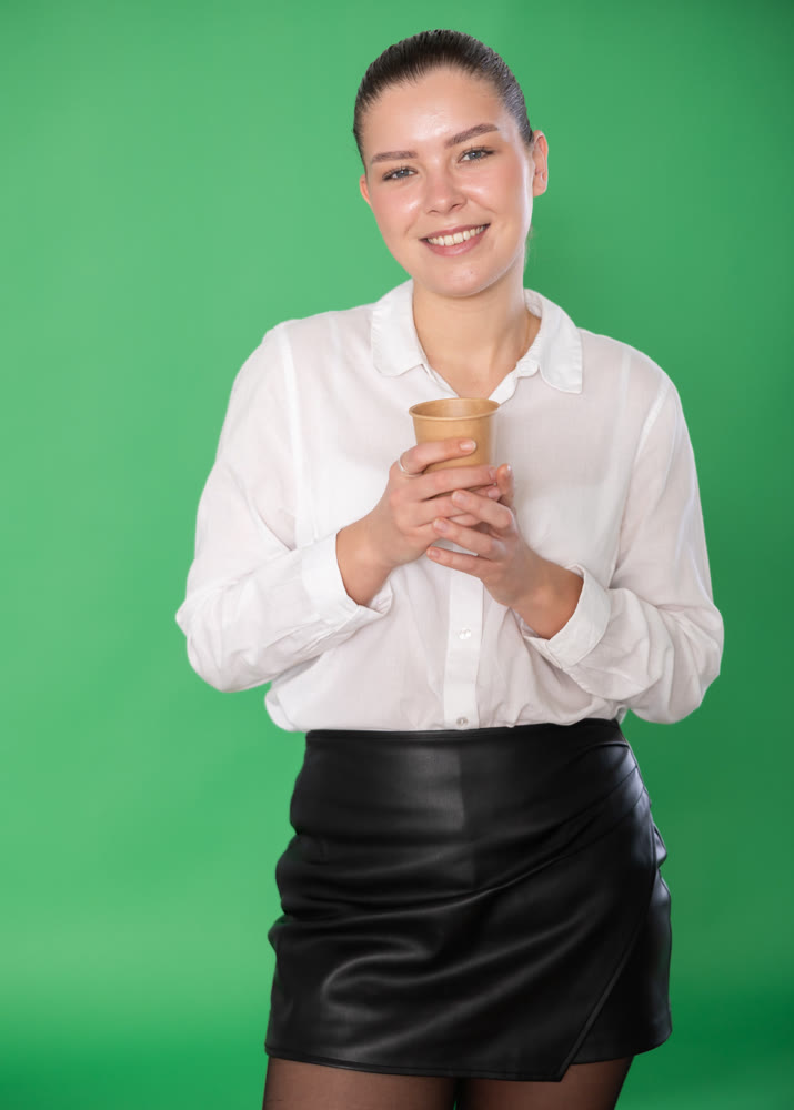 Young woman and coffee break on green screen background
