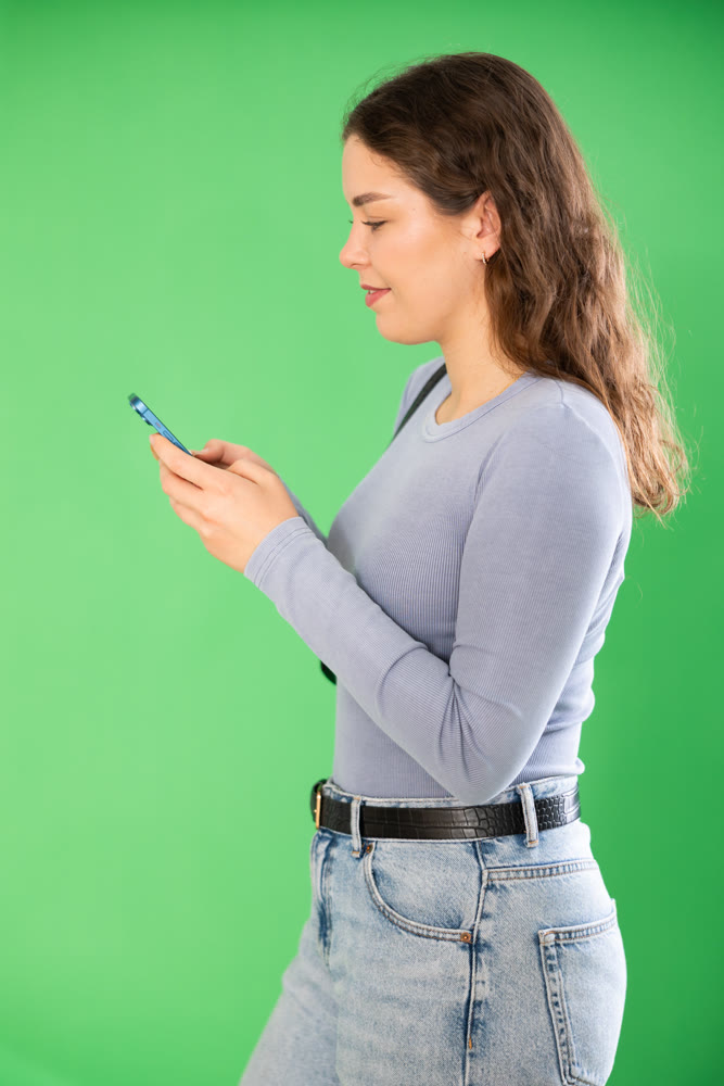 Female person girl scrolls phone screen or types text message