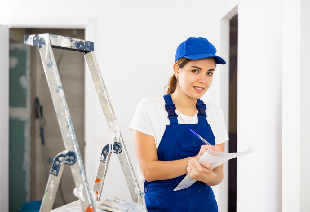 Portrait of builder woman who checks completed work on