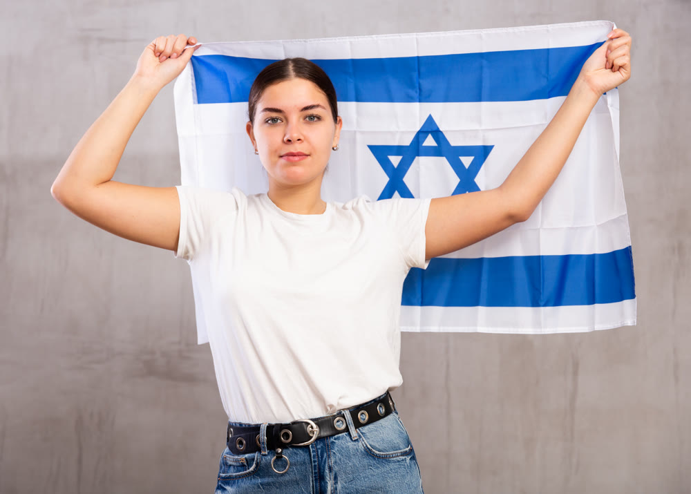 Pretty girl holding the Israel flag in her hands