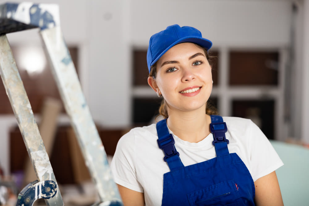 Woman builder standing in apartment