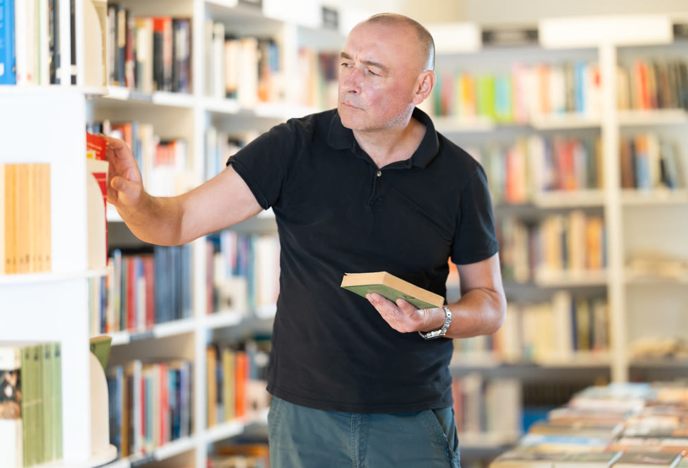 In bookstore man choose book