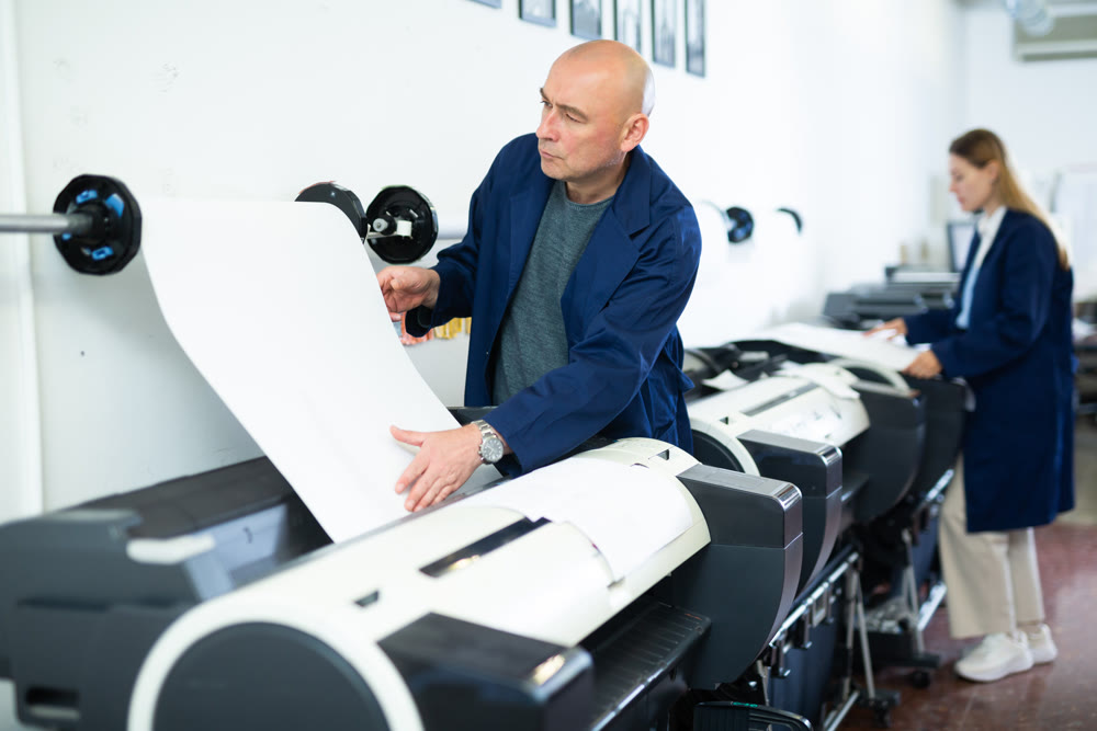 Man using printer while working in print shop