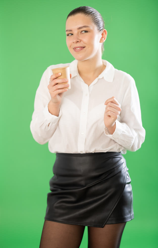 Young woman and coffee break on green screen background