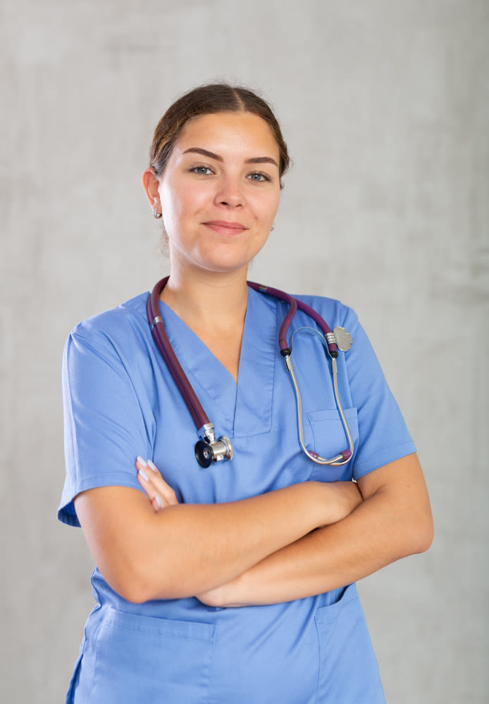 Young woman posing in medical uniform in studio