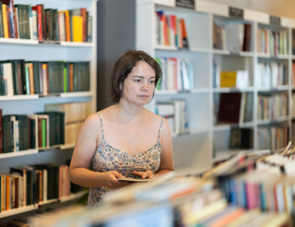 In bookstore woman choose book