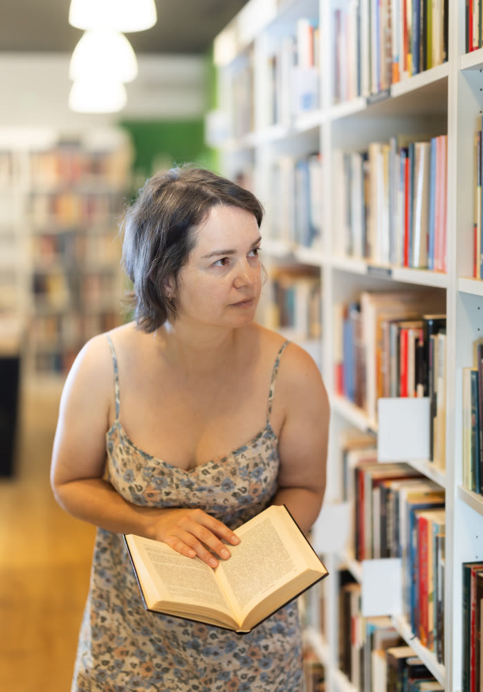 In bookstore woman choose book