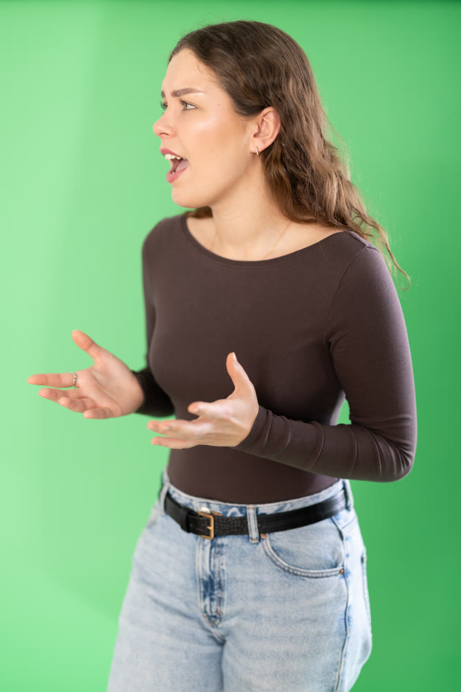 Outraged European young woman is yelling at someone