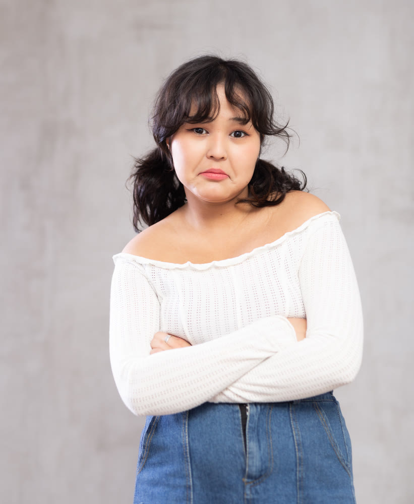 Portrait of upset young girl posing in studio