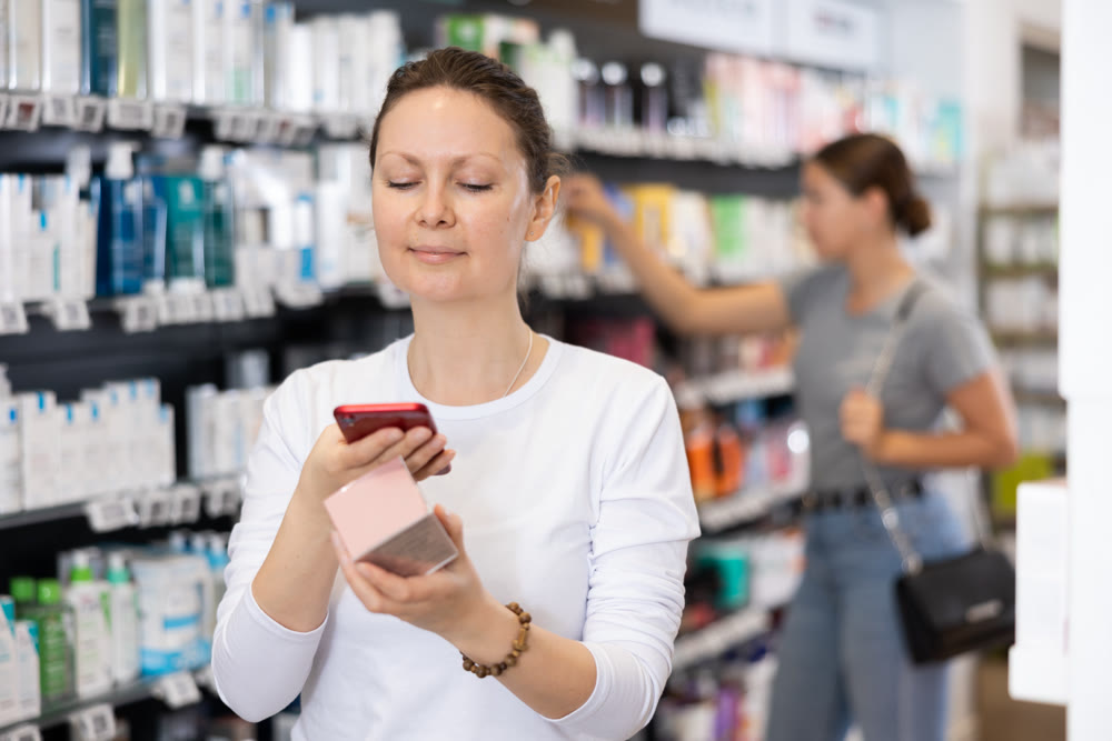 Adult woman looking for cosmetic product from photo on internet