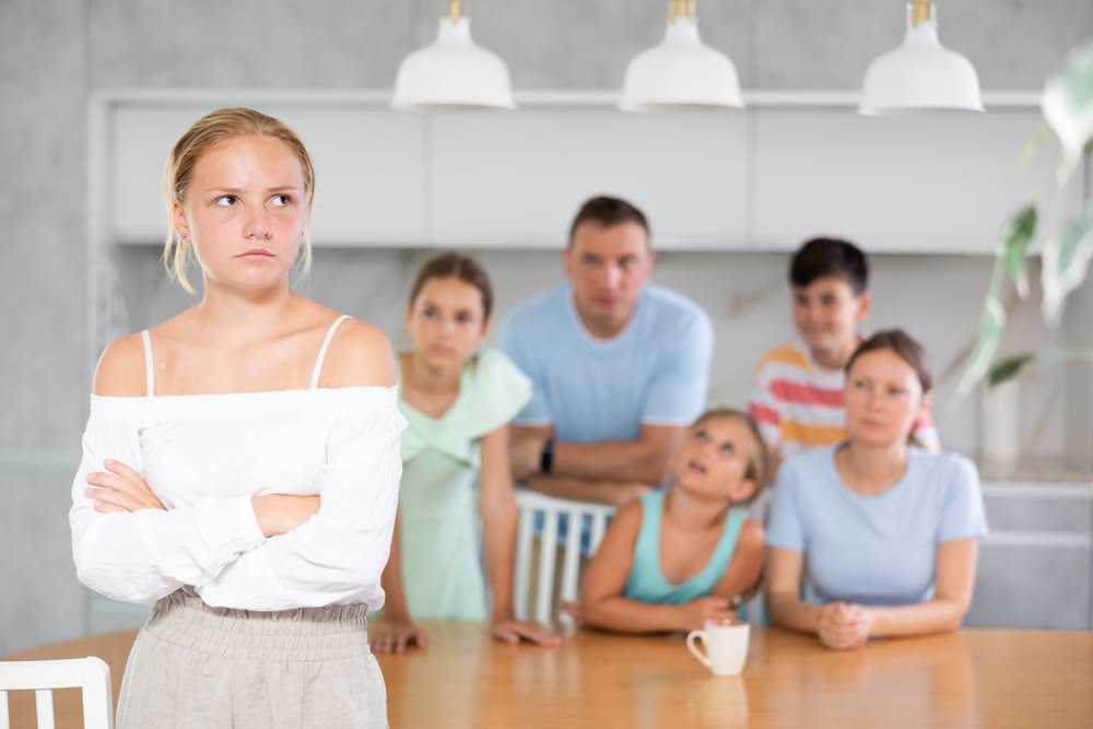 Offended teenage girl turned away from her family. Family quarrel