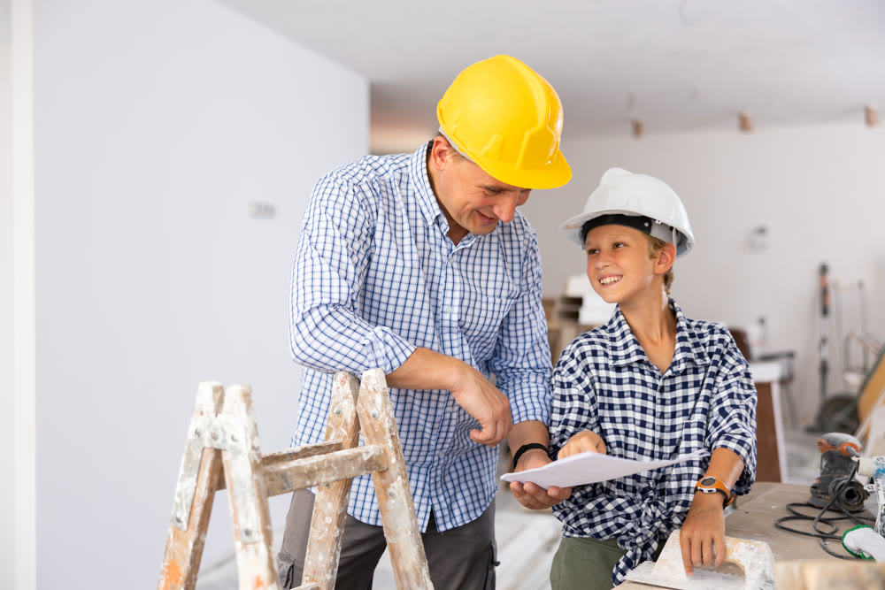 Father with little son talking about repair work in the apartment