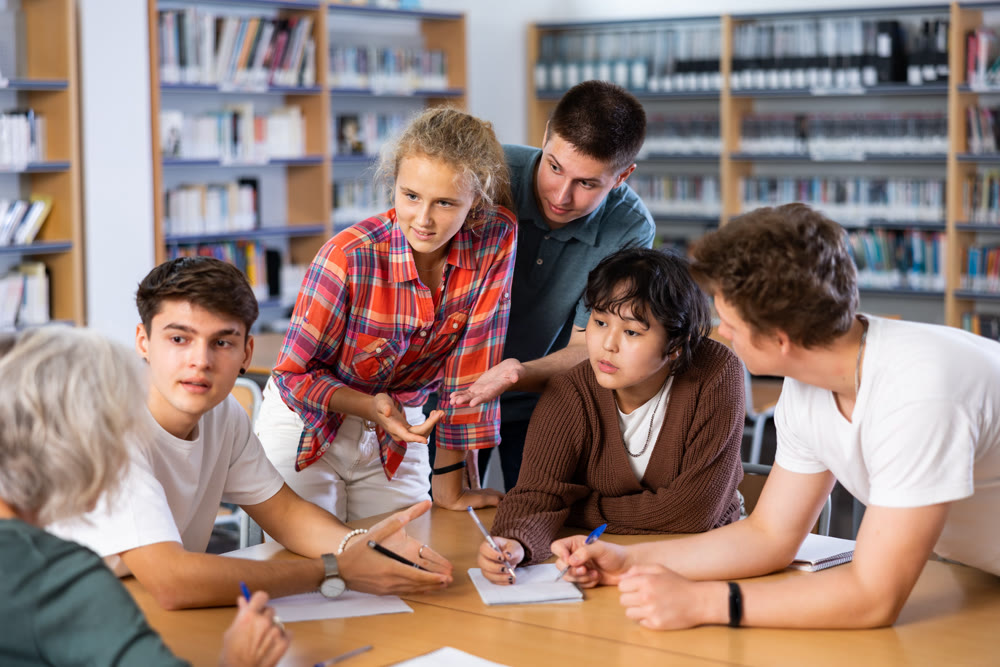Brainstorming teen students in school library