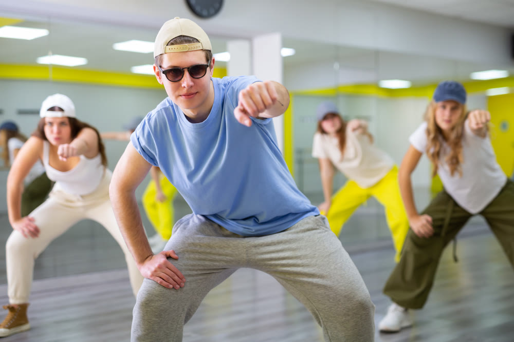 Teenage boy training breakdance Toprock moves in dance hall
