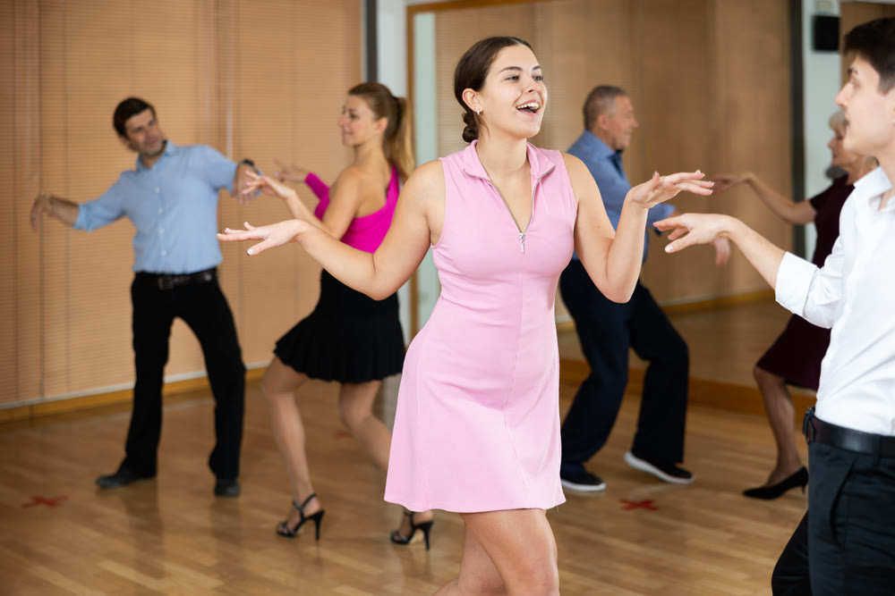 Young pair practicing Latino dance in dance studio