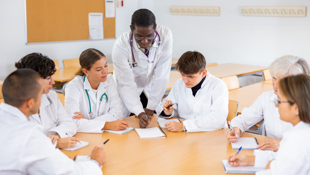 African American professor of medicine giving lecture to group of internship doctors