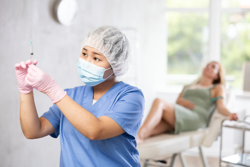 Doctor anesthetist checks the syringe before injection to patient