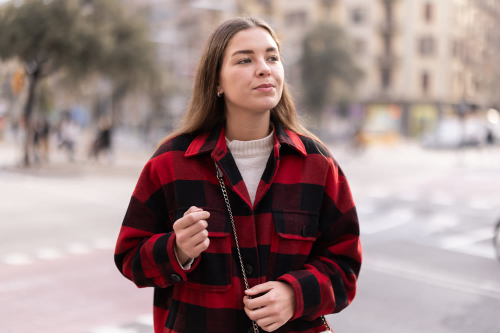 Young woman walks through square of city