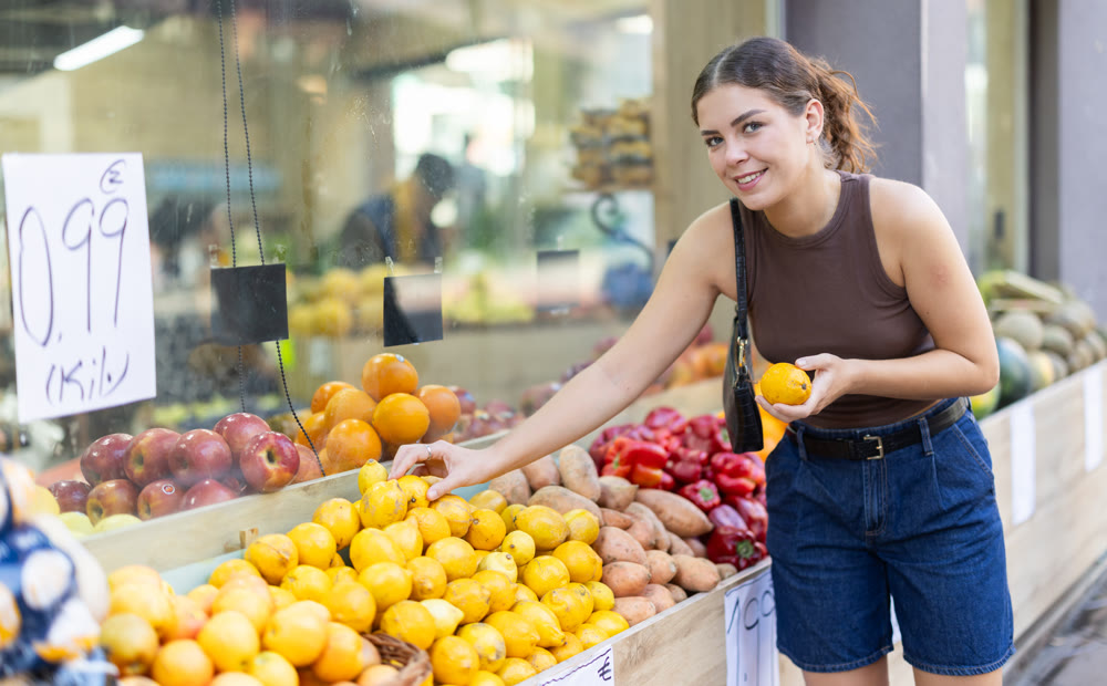 Woman choosing fresh fruits at outdoor street market