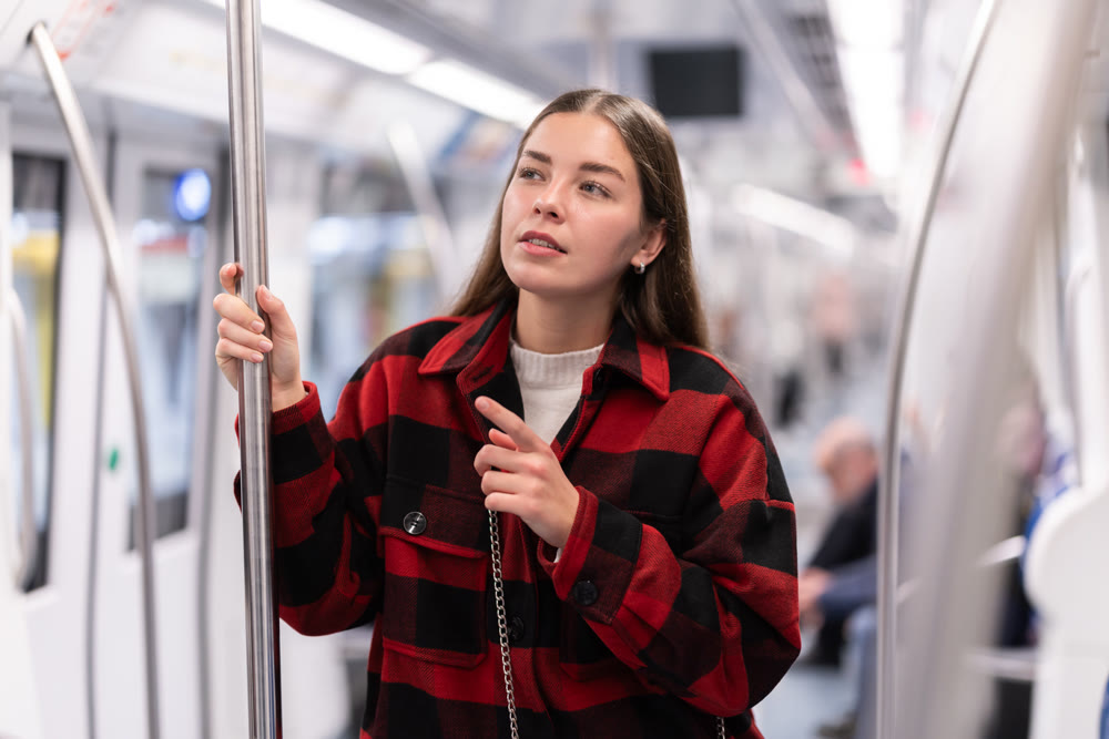 Girl is standing in subway car, getting to work