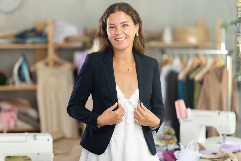Woman trying on a jacket in the workshop