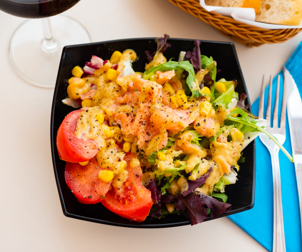 Salad with smoked salmon, tomato, corn, greens