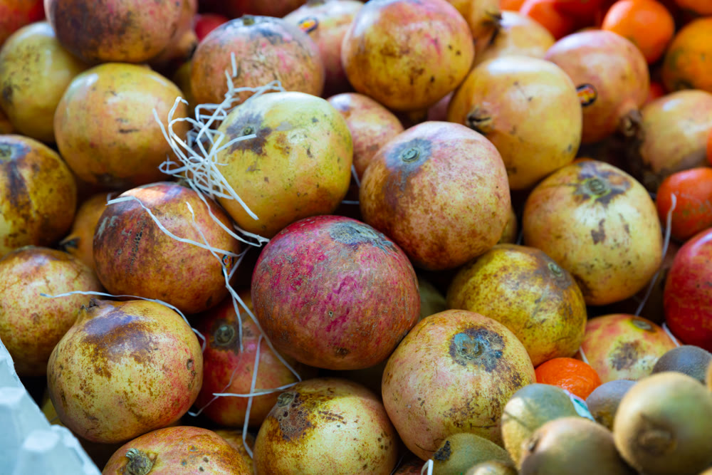 Fresh ripe pomegranates in box for sale