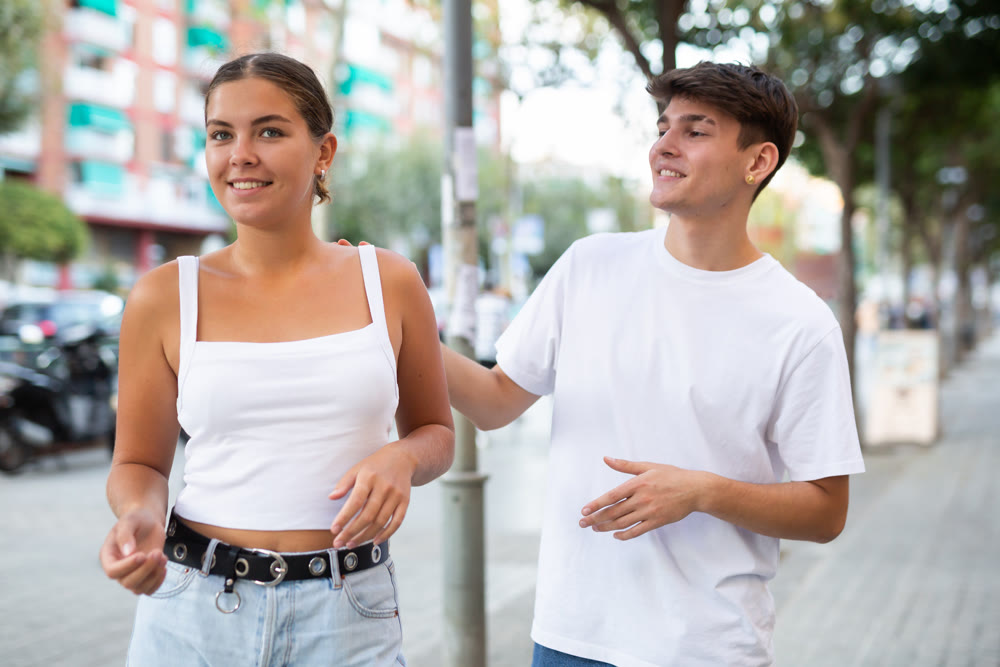 Young man trying to acquaint with girl outdoors