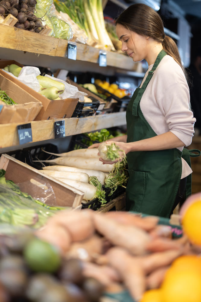 Farm shop owner offering organic radishes