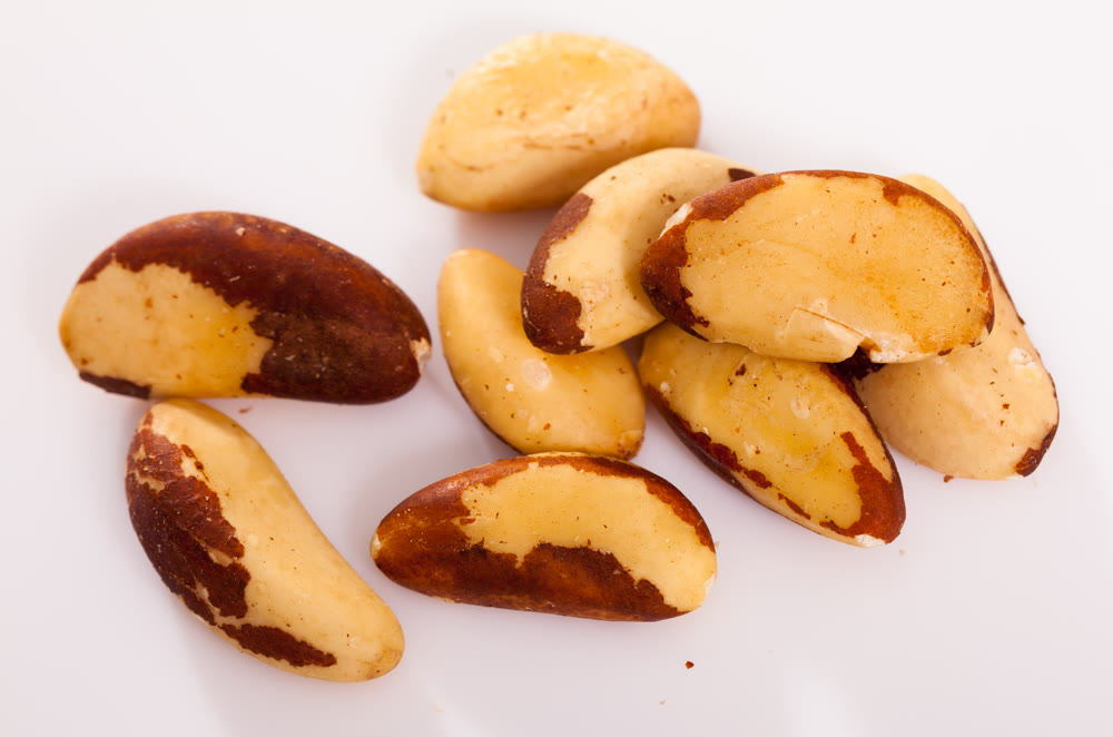Brazil nut seeds on white surface