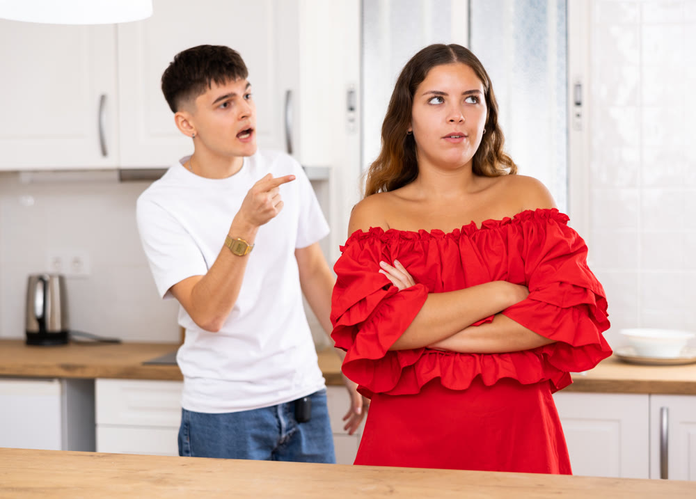 Domestic quarrel of a young family in kitchen