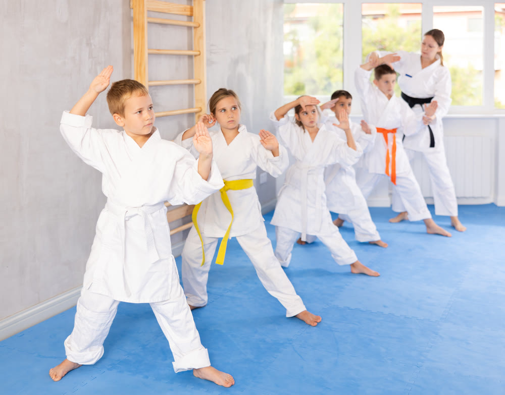 Young karate students gather in dojo