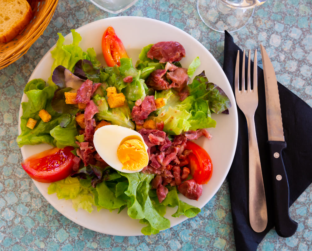 Deliciously salad of lettuce, sausage, tomatoes and boiled egg