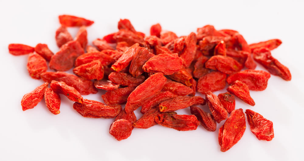 Heap of dried goji berries on white