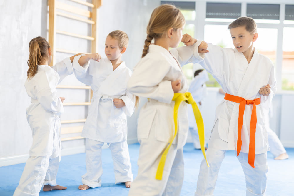 Young pupils train to perform defensive karate installations and attacking combat techniques