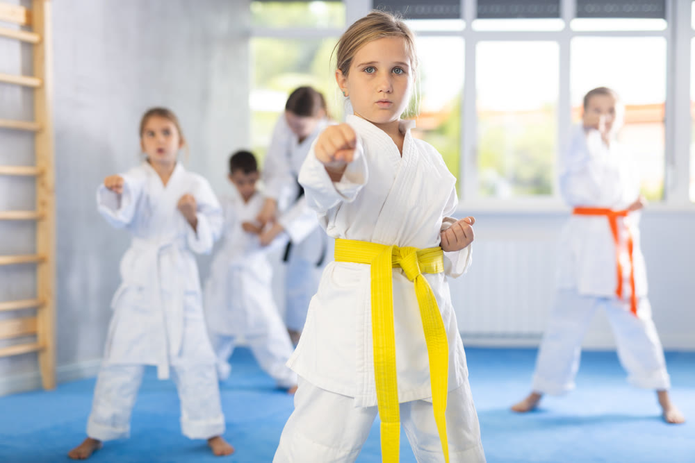 Young karate students gather in dojo