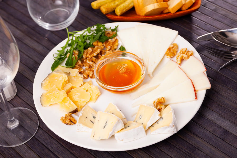 Various types of cheese on white plate
