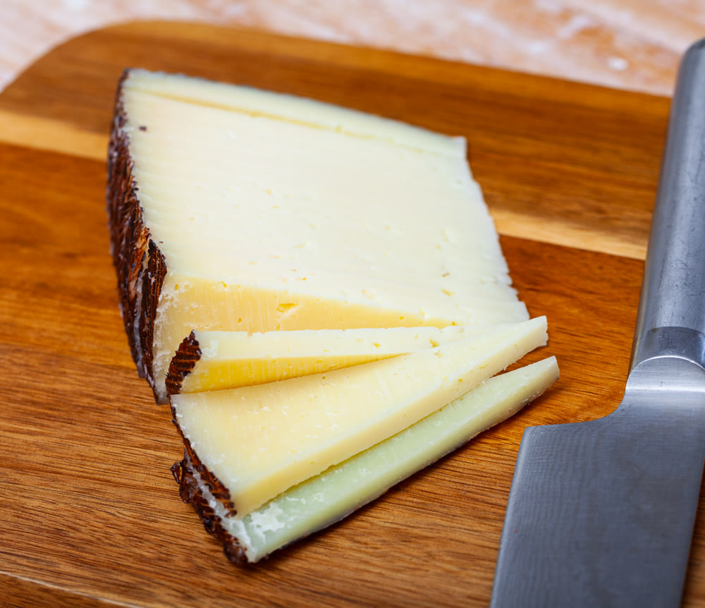 Sliced semi hard spanish sheep cheese Manchego, nobody