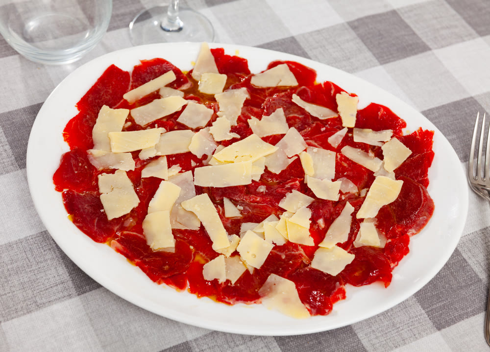 Carpaccio and cheese served on plate