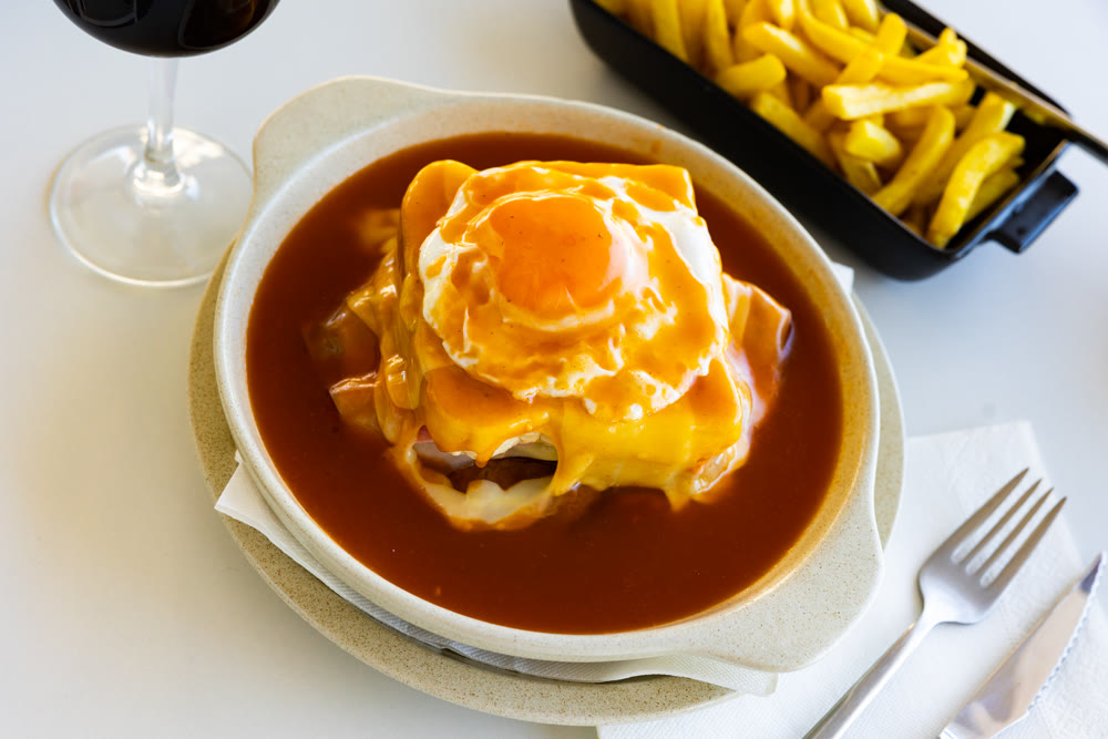 Typical portuguese sandwich like croque monsieur called Francesinha with cheese and steak