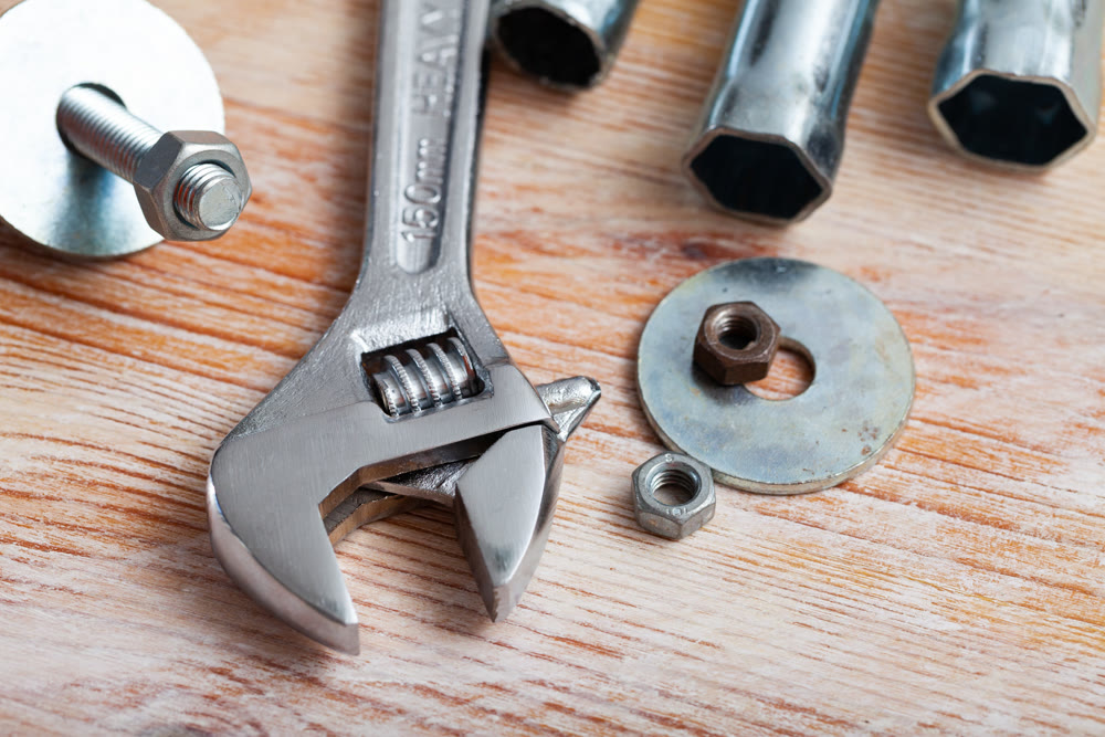 Adjustable wrench on wooden background